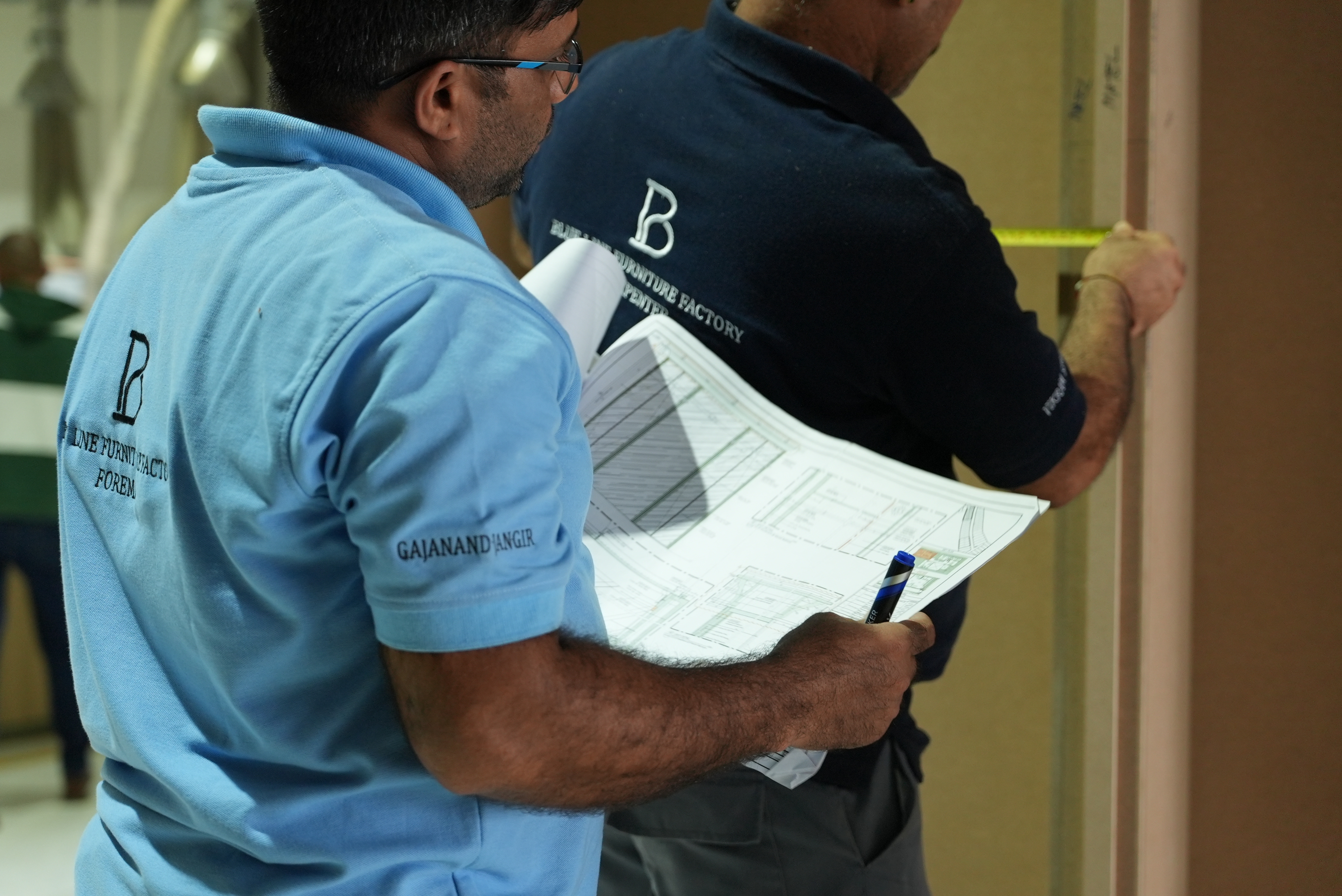 Blueline team reviewing fit-out blueprints on site