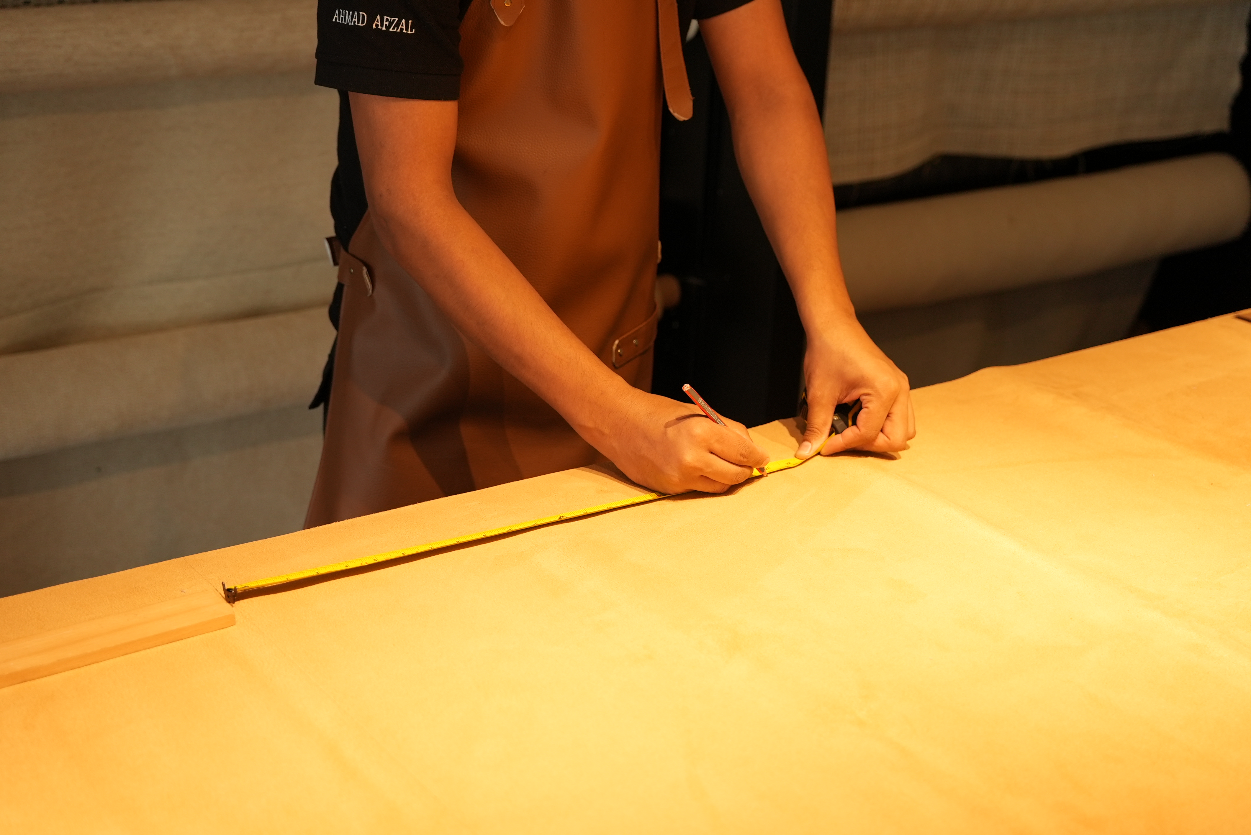 Craftsman measuring timber — Blueline joinery workshop